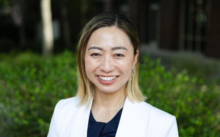 person standing outside in a white shirt